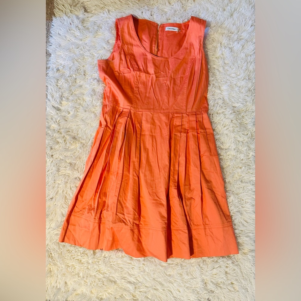 Peach color Calvin Klein dress.